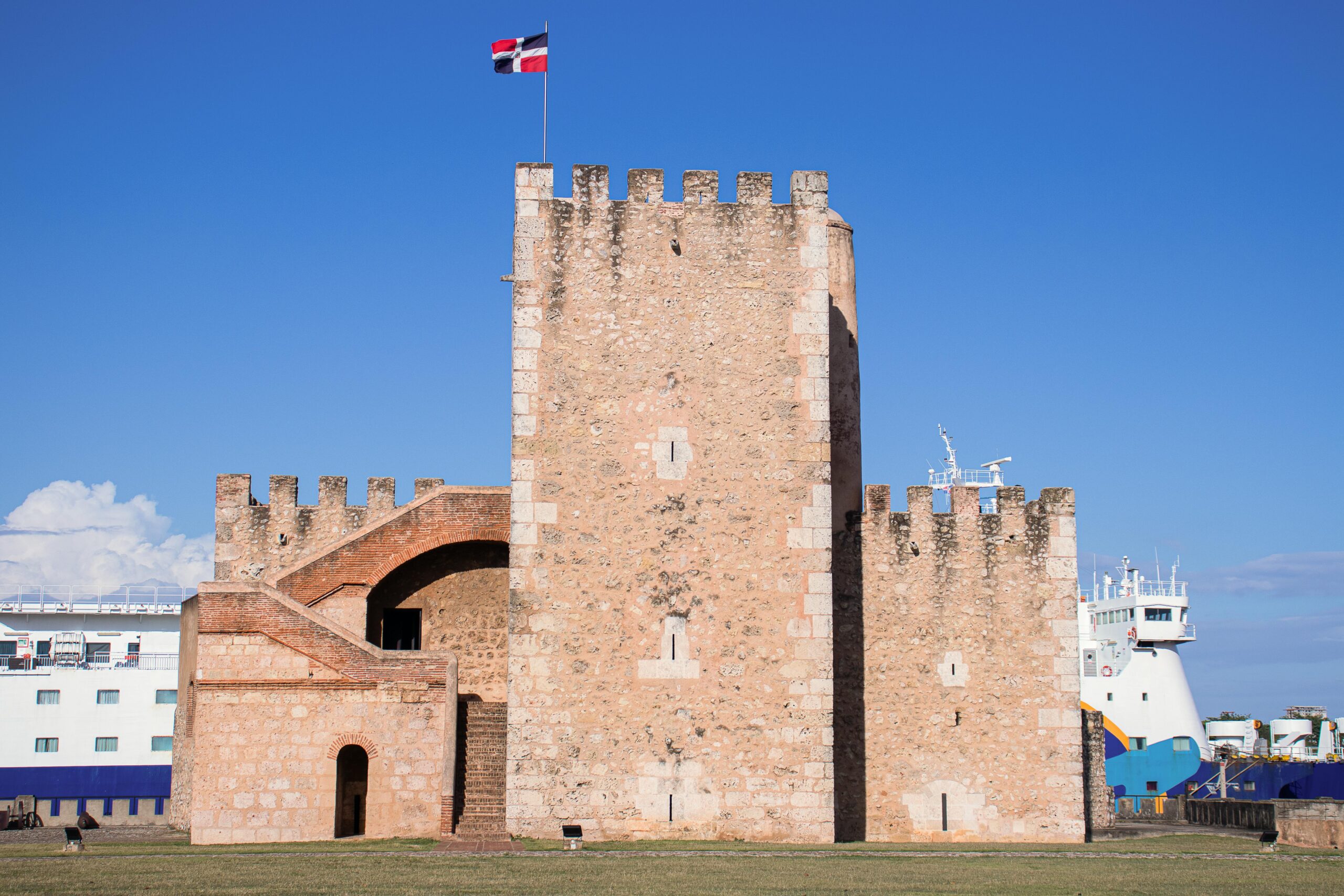 Old stone fortification, Fortaleza Ozama, under clear blue sky in Santo Domingo, Dominican Republic.